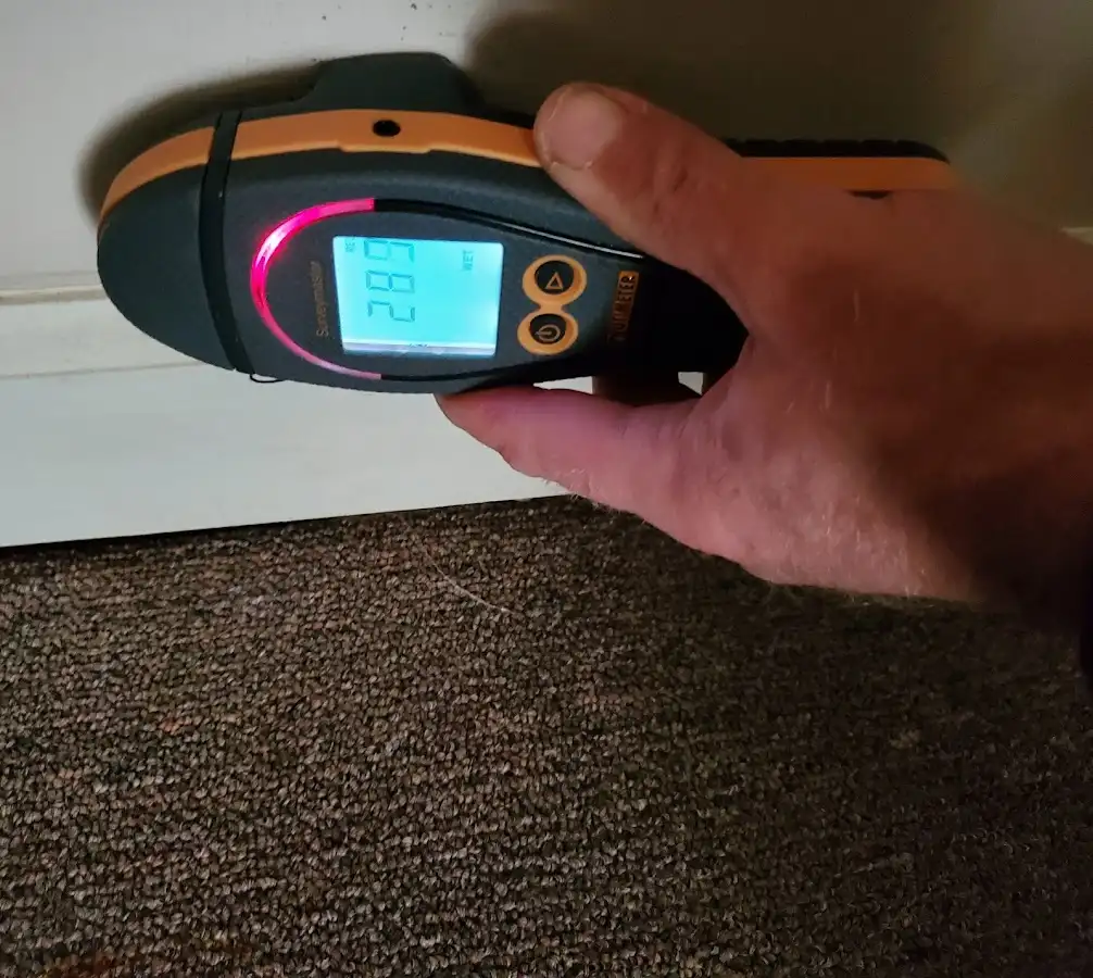 Moisture detection at baseboard during Storm Damage Restoration in Sutton
